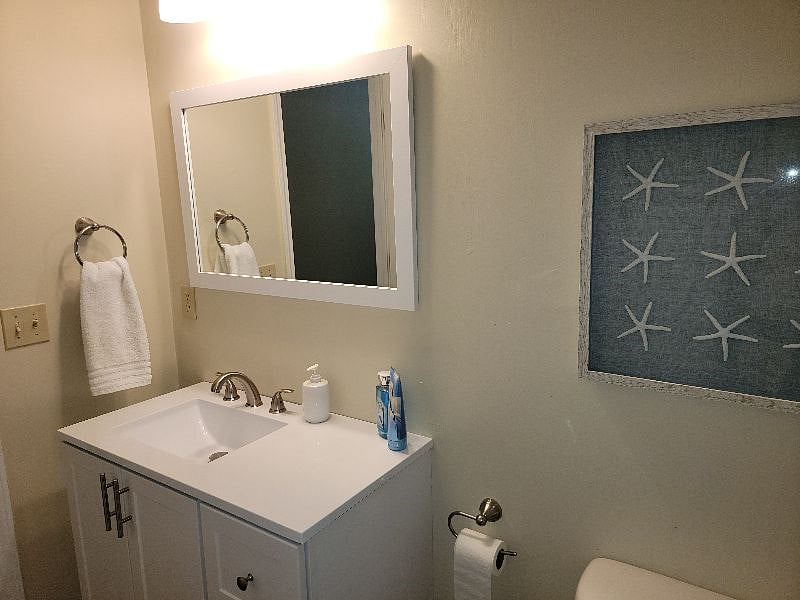 Full bath located off hall, next to bedroom two