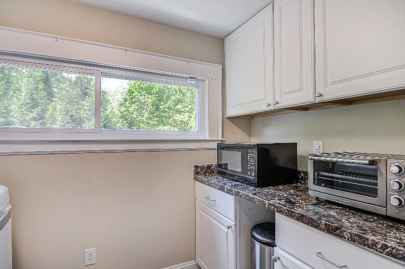 Pantry | Microwave and convection toaster oven with broiler. Plenty of cabinet storage for pantry items.