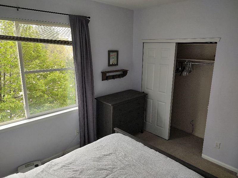 Closet space with shelves and hangars as well as dresser.