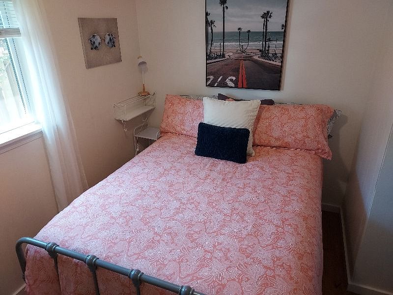 Queen bedroom, rear.  Bright and beachy vibe.