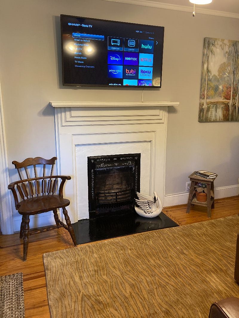 Original fireplace (non-working). If you look close, there are rose inlays engraved in the antique metal cast iron FP insert.