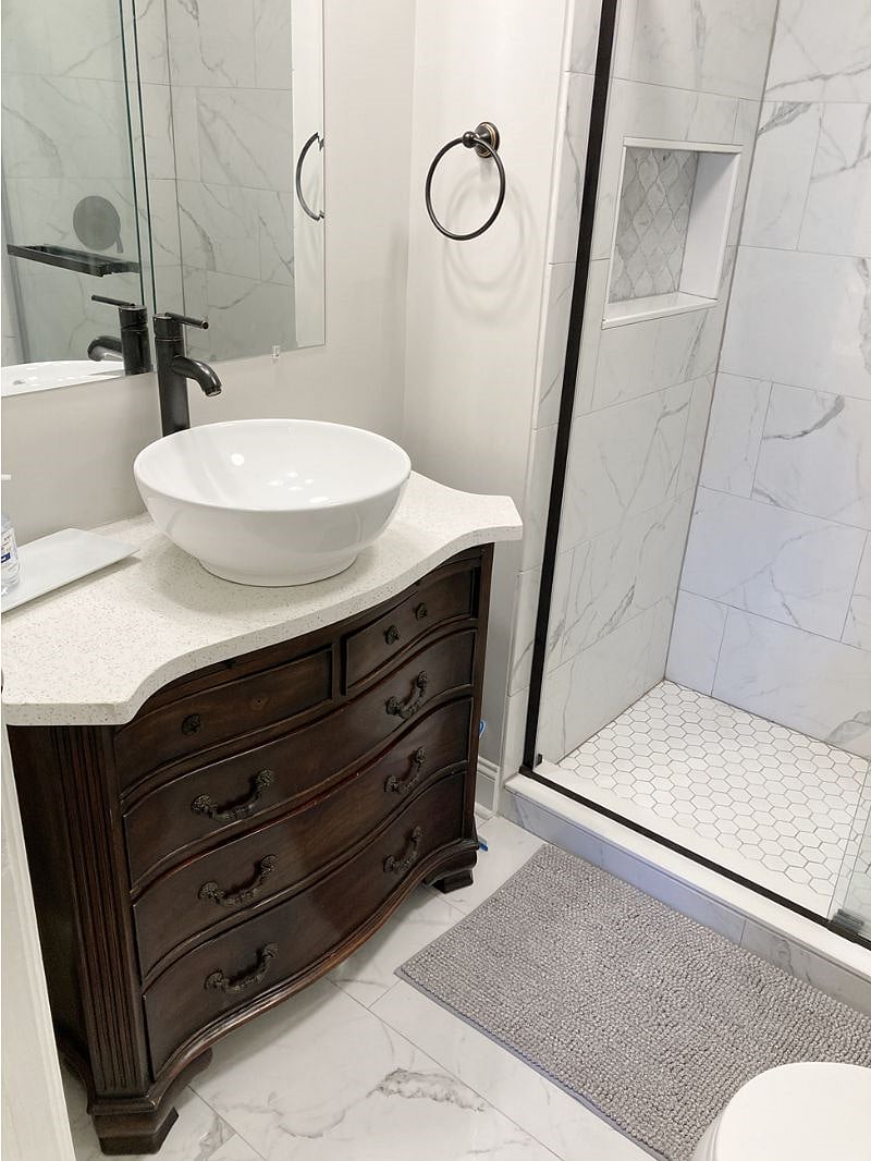 Custom cut vanity top to match the furniture shape and a white bowl