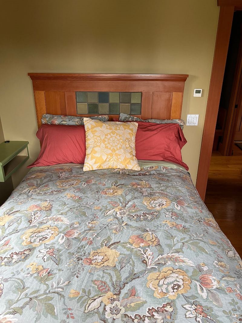 Bedroom with full size bed (but extra long) along with built in drawers for storage and 2 closets.  All bedding (plus extra set) provided.