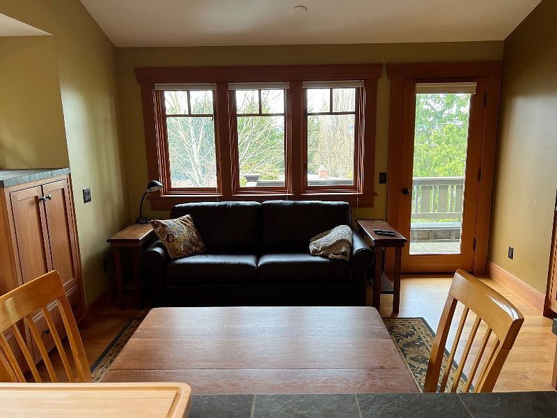 Table and chairs, brand new leather couch, lots of built in cabinets + another door to access private deck to the west.