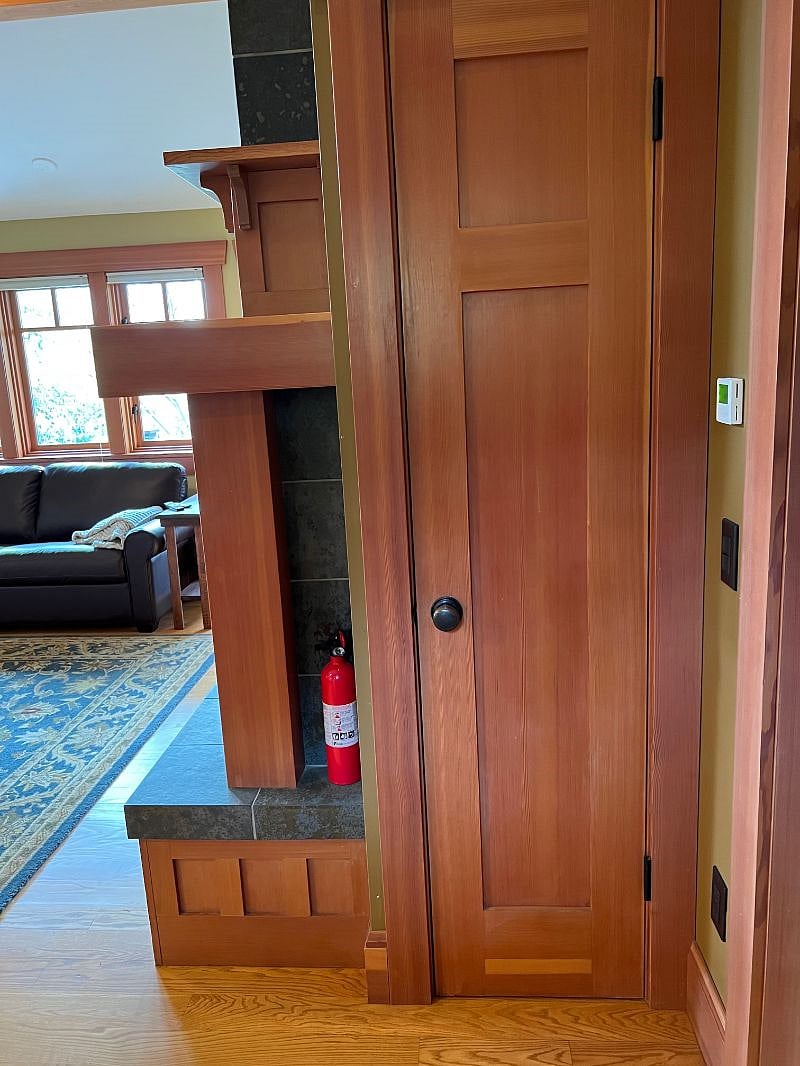 View of a closet and living room as you walk into your place.
