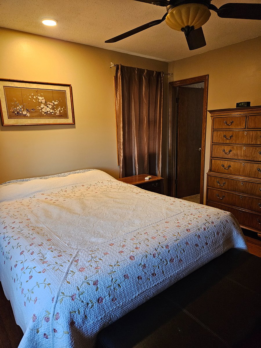 Master bedroom, door to half bath