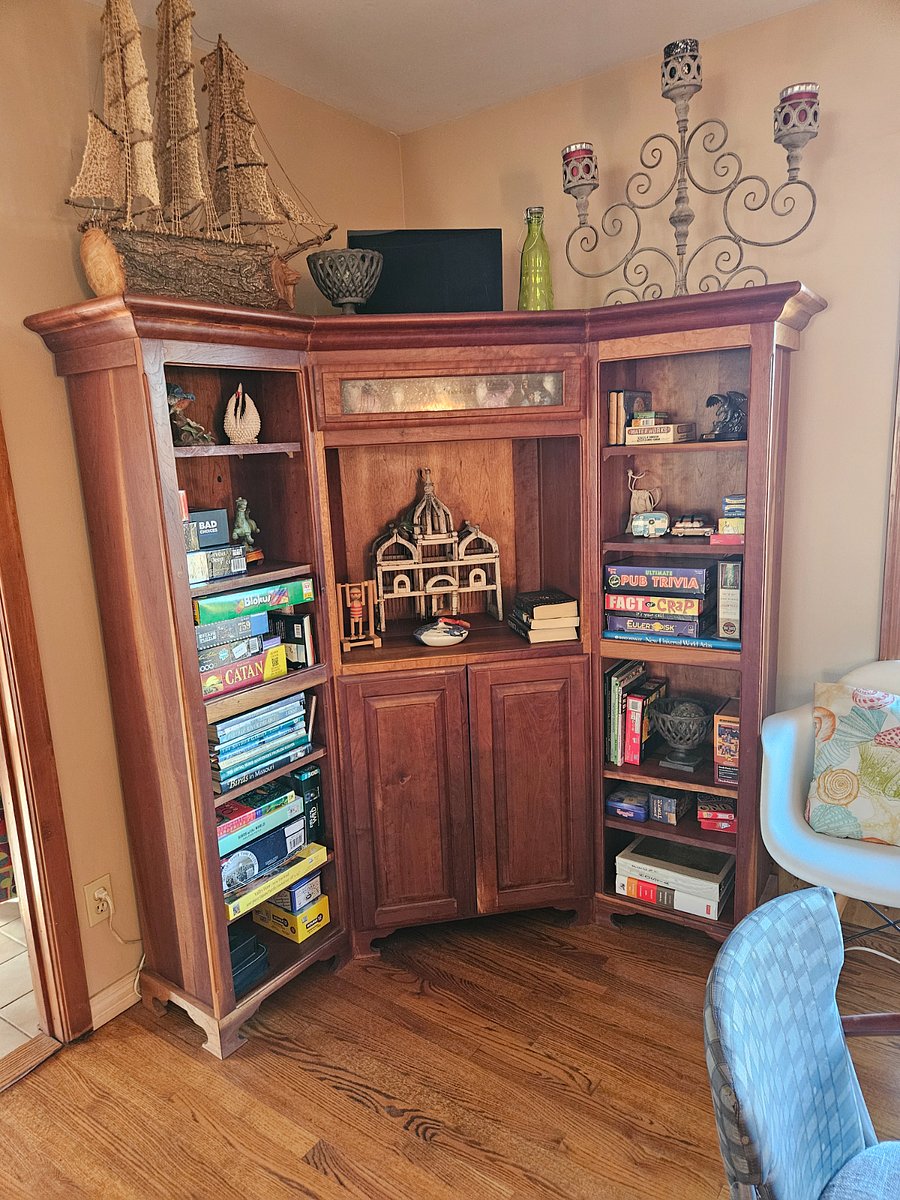 Cabinet in dining room loaded with puzzles and games.