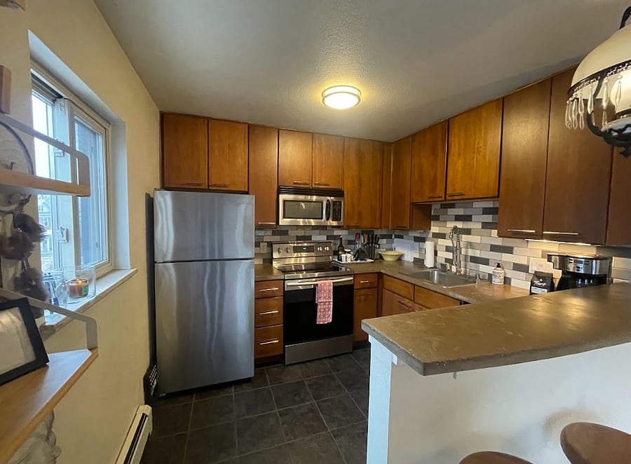 Fully loaded kitchen with spices and cookware.