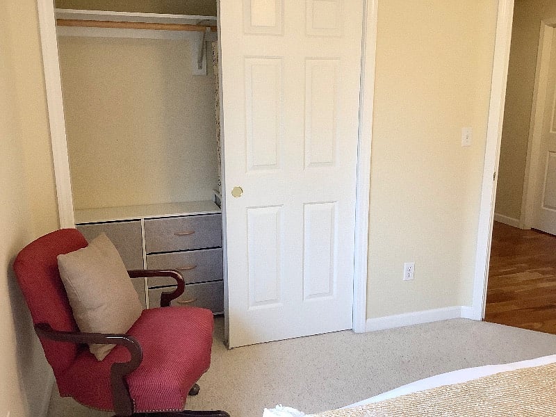 A small dresser on one side of the bedroom closet.