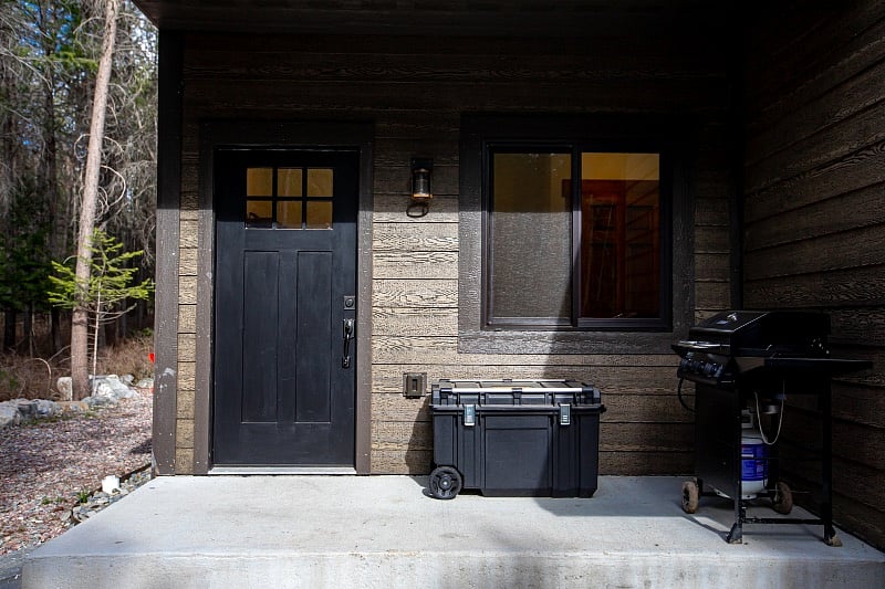 Mud room entrance with covered porch and BBQ grill 