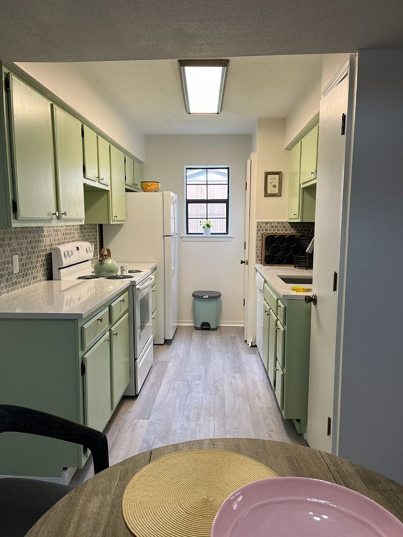 Fully-functioning kitchen. The first door is a handy pantry; the second door contains your washer and dryer