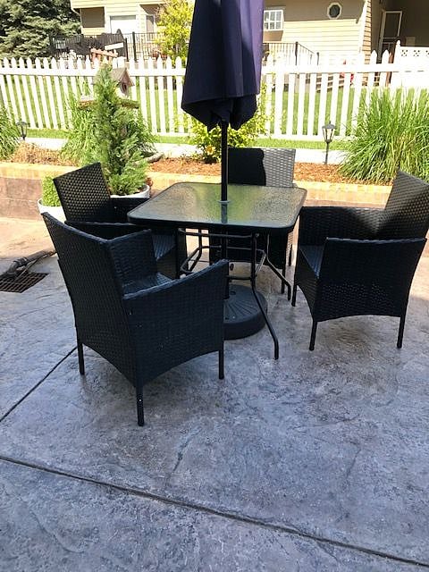 Patio set includes umbrella which is located in recessed patio overlooking the beautifully landscaped backyard.