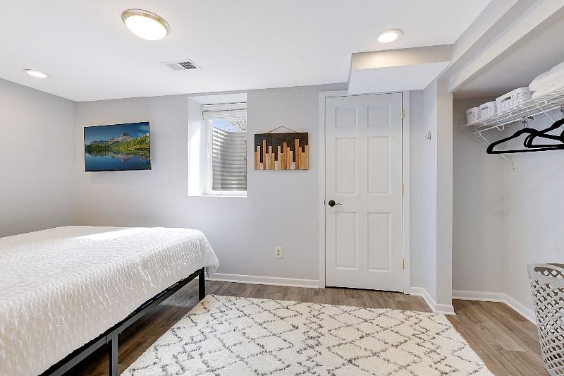 Lower level bedroom is a completely private and large room on its own level with a private bath and a QUEEN-sized bed, sitting chair, smart TV and large closet with an organizer system for all of your needs.