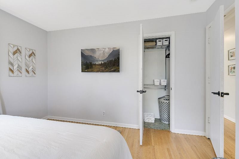 Main floor bedroom 1 - King bed, large clean and fresh closet with organizer system plus lots of hangers and baskets for all of your storage needs