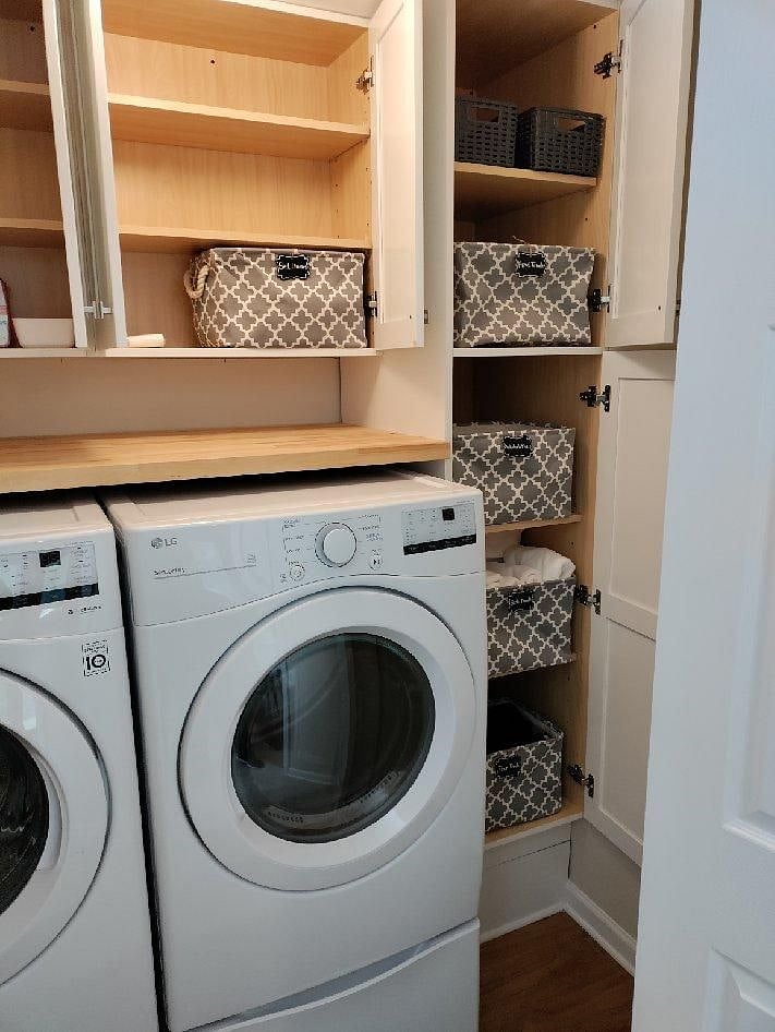 Laundry space off bathroom with towels and linens