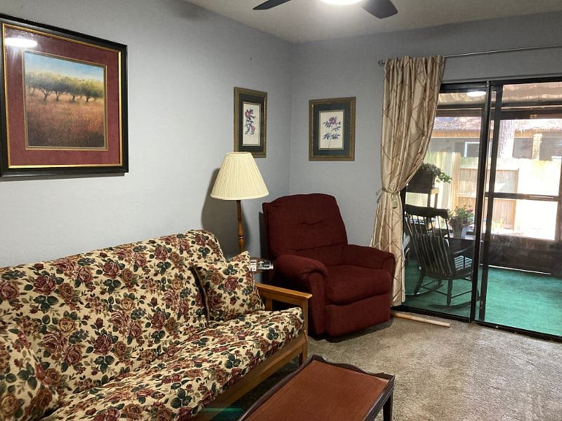Bedroom 2 set up as guest/TV room with futon, Lazy Boy, wall mounted TV