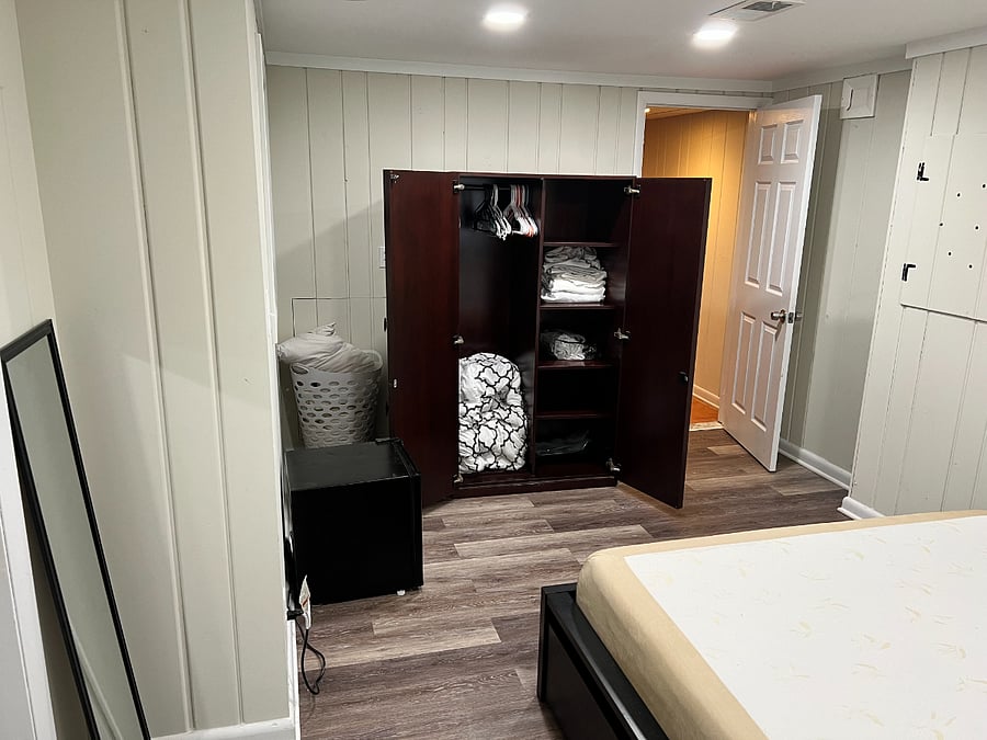 Bedroom - open cupboard and mini fridge