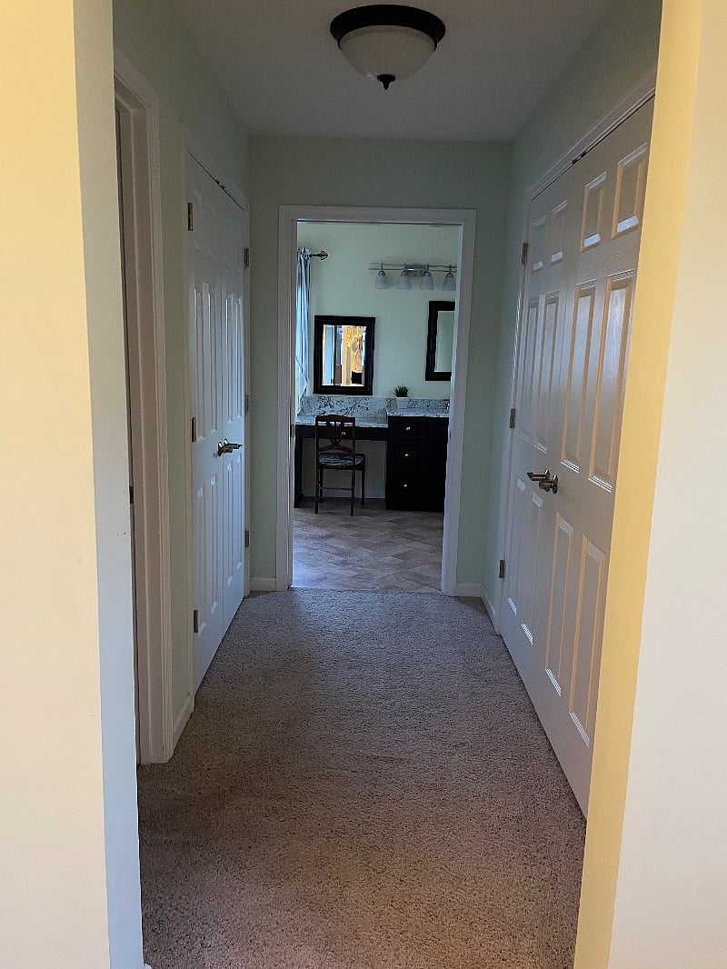 Looking into large bathroom from bedroom.