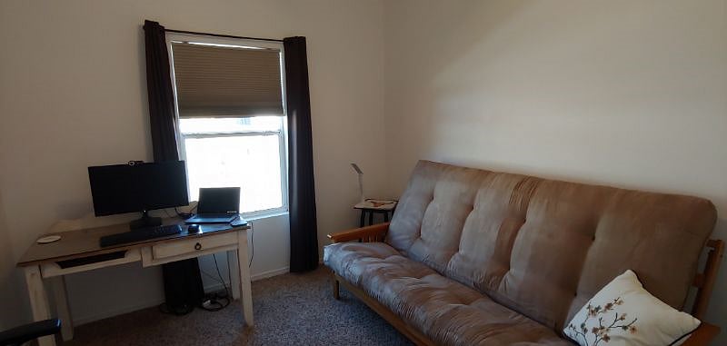 Third bedroom has a desk and a queen size futon and a walk in closet