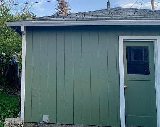 Detached washer and dryer unit in back of house.