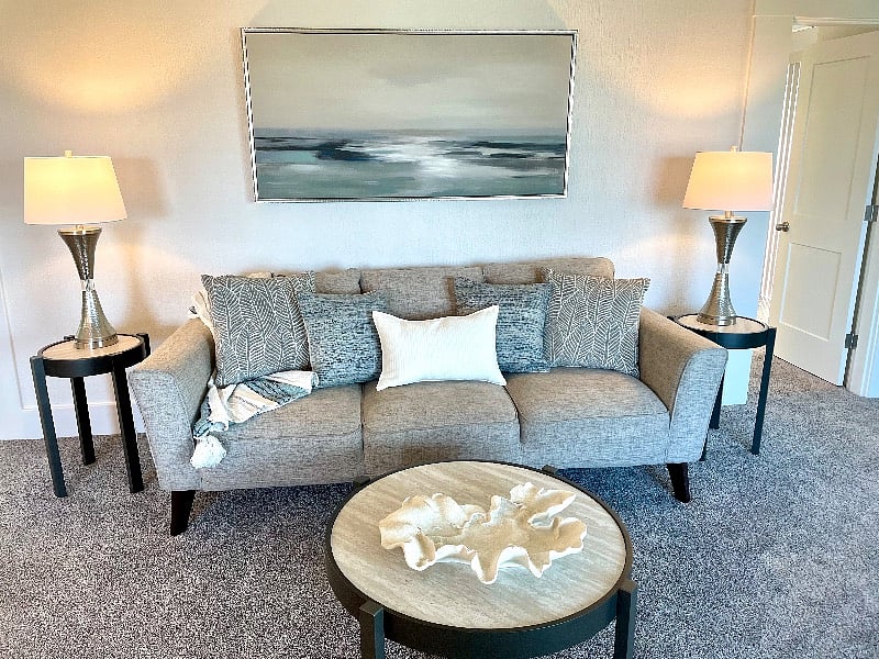 Family Room with cozy couch, dining room table for 4 and desk.