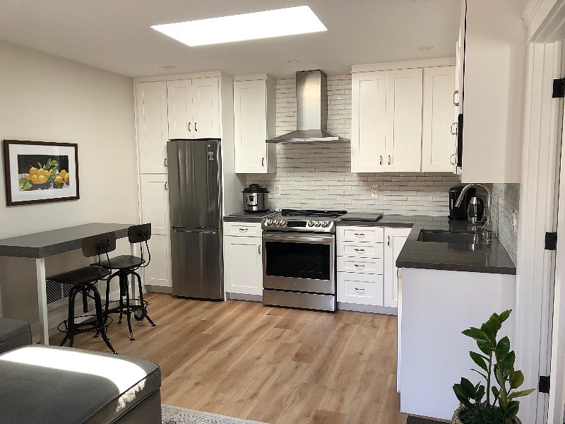 fully equipped kitchen with stainless steel appliances.