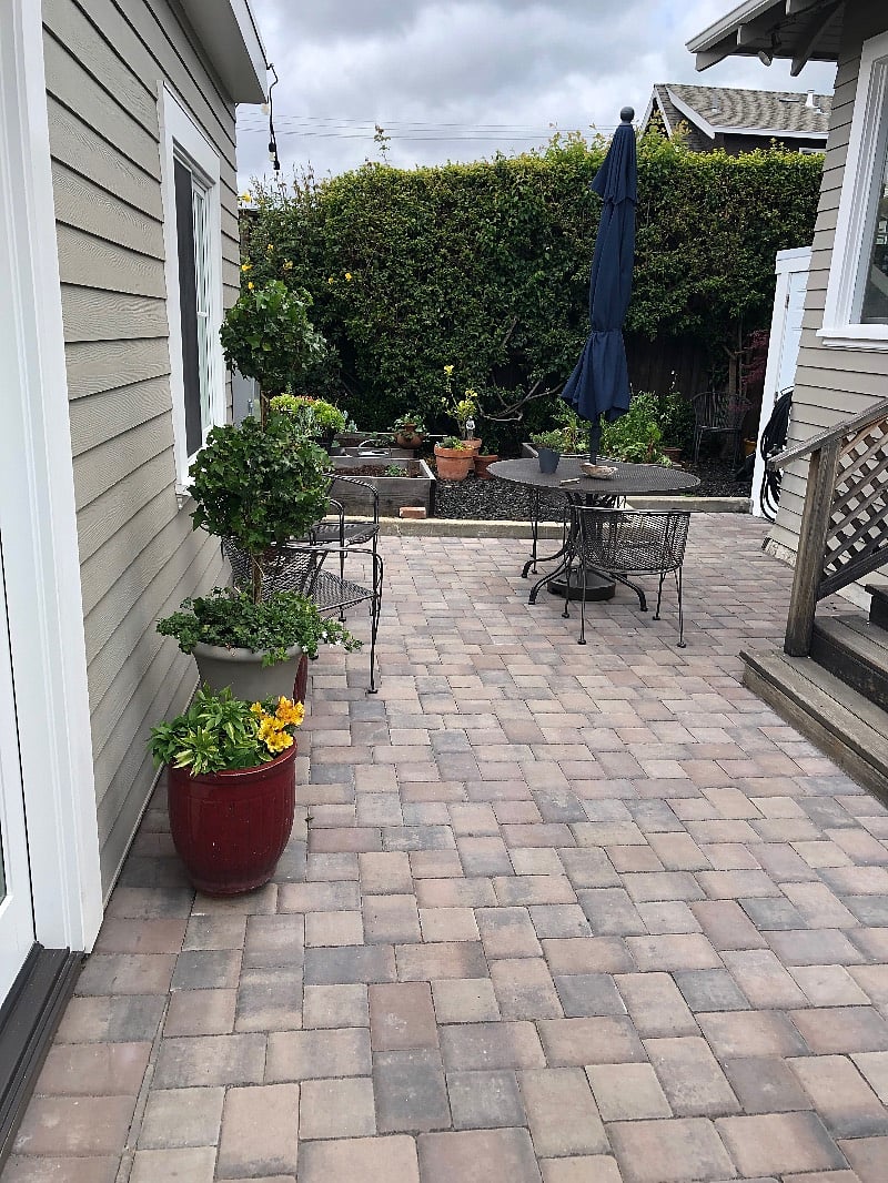 patio table and raised organic vegetable garden space shared with homeowner