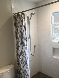 curb less shower, porcelain tile flooring.