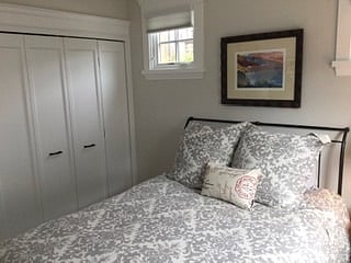 closet with shelving and clothing rods.