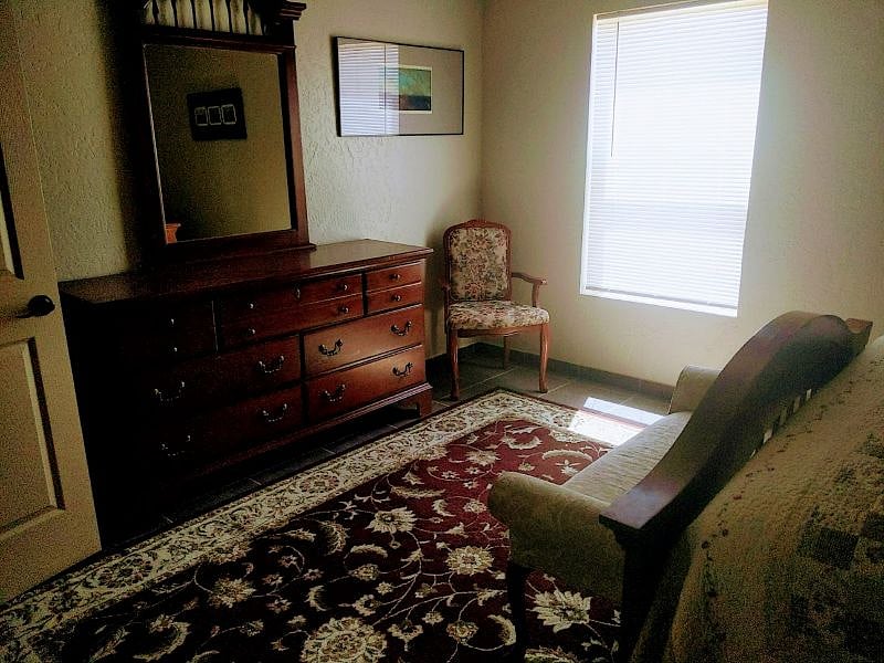 Master bedroom overhead fan. One  window with mini blind. Basset furniture all the comforts of home.