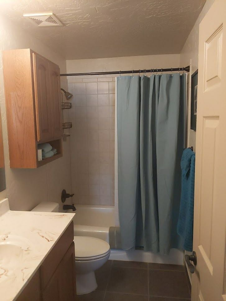 bath has towels tub/shower combo. Soap dispenser. 