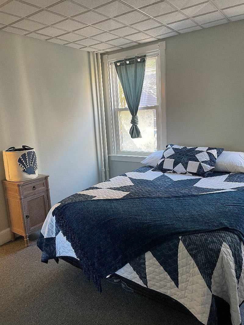 Bedroom #1. Queen size bed, night stand, lamp, dresser and closet. Tinted windows with dark out curtains. Bedroom #1 has carpet.