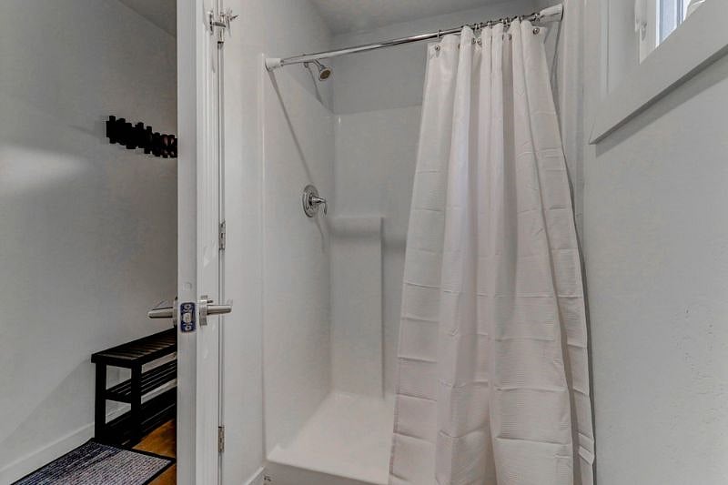 The bathroom features a standing shower