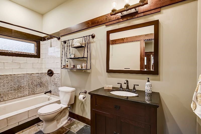 Full-size bathroom with oversized antique washed tile.
