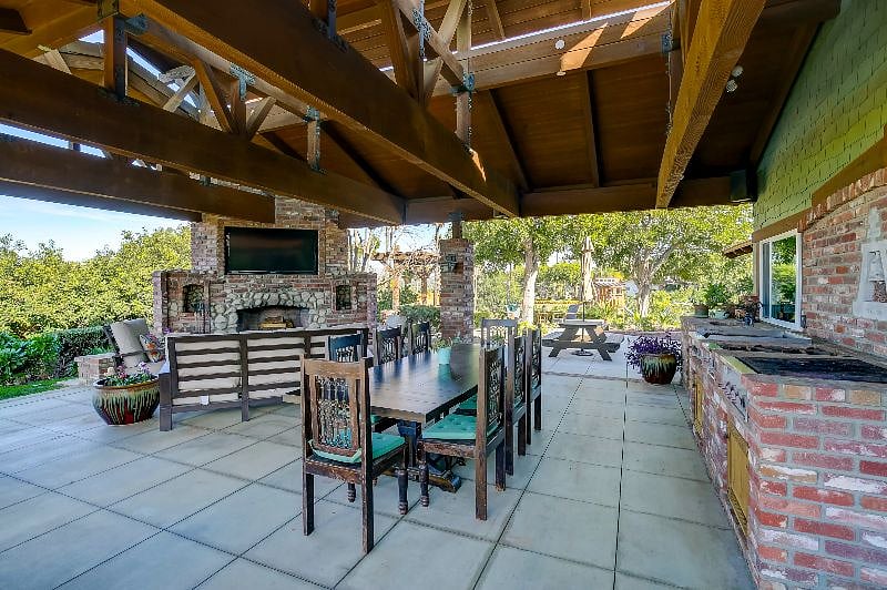 This is the upper house outdoor living room looking towards the wood fireplace.
