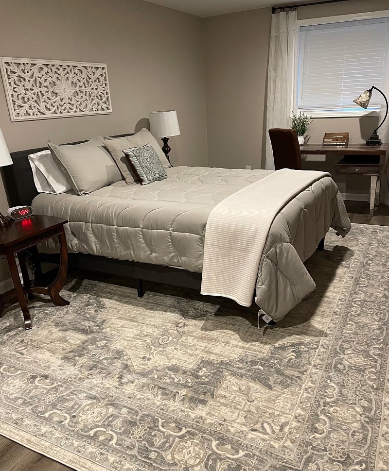 At the end of the day, this queen-size bed will feel so good! There's a double dresser opposite the foot of the bed and a full-length mirror on the wall.