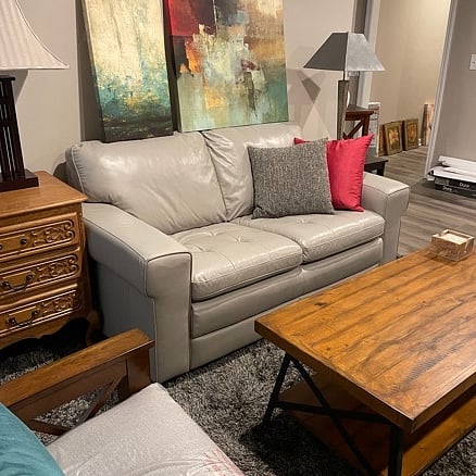 Living Room with leather loveseat, two comfy chairs, coffee table, TV, and internet. This room has two windows looking out onto the patio and garden, plus a door with a sturdy deadbolt lock.