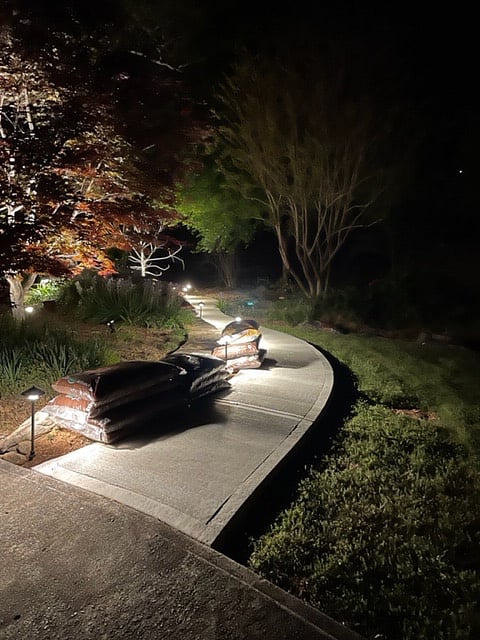 A well-lit walkway leads from the driveway to the private entry of the apartment. Lights come on automatically at dusk, so schedules are not a problem.