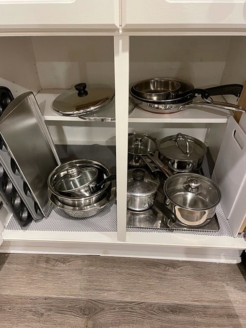 An assortment of stainless steel pots and pans is ready for use.
