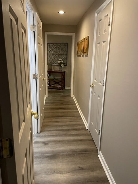 The hallway leads from the bedroom to the living room and kitchen.