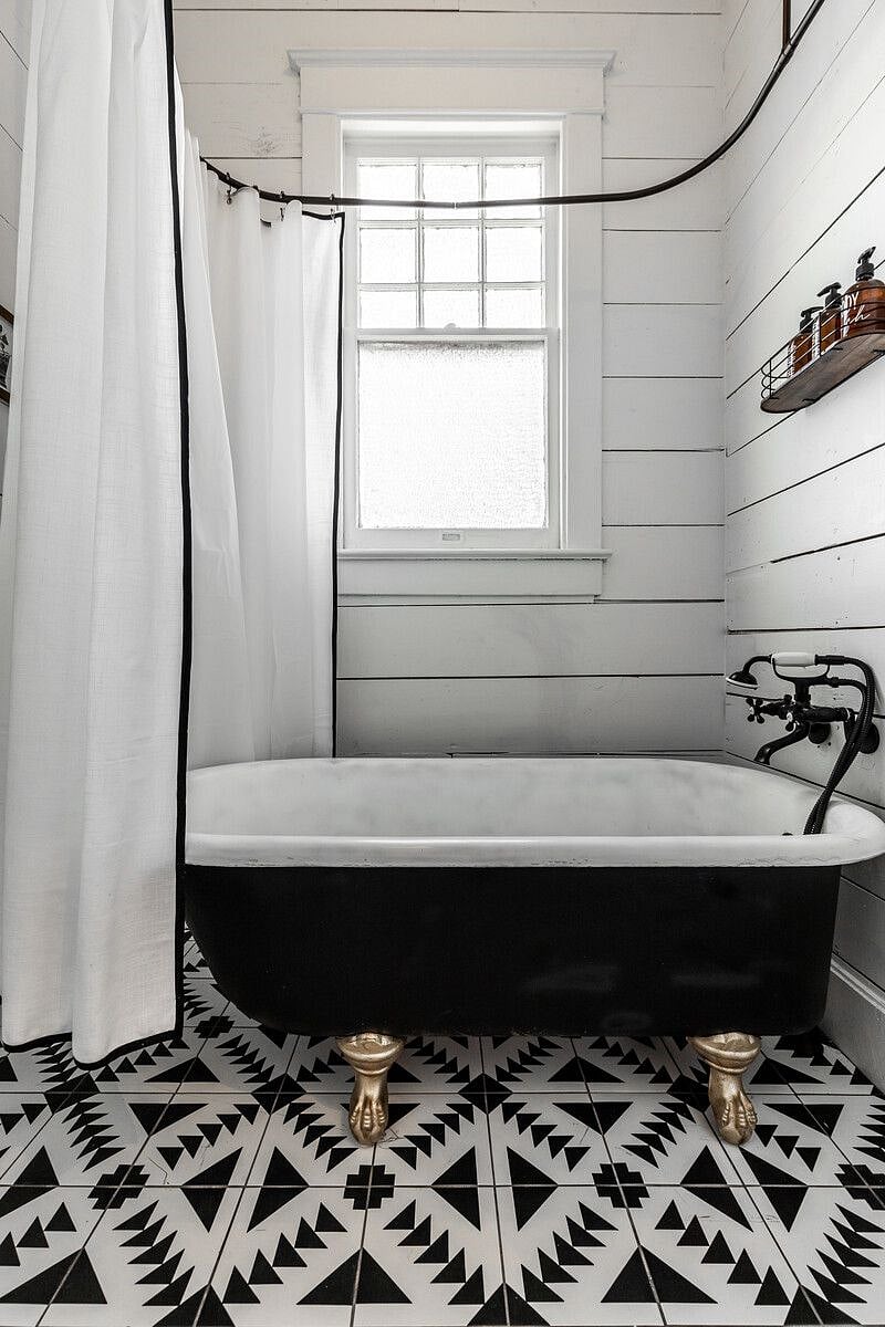 The original clawfoot tub has been refinished and includes a new faucet with shower handle.