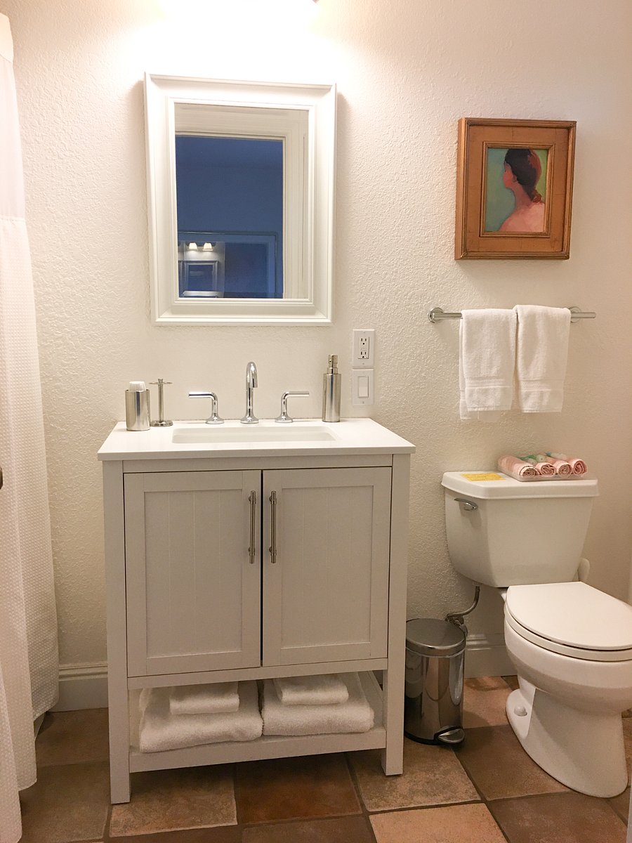En suite bath has tiled, low curb walk-in shower