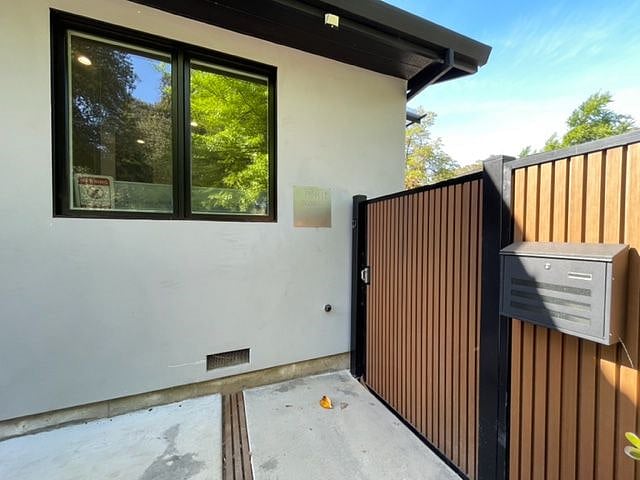 Locked gate goes to side yard and private entrance to unit.