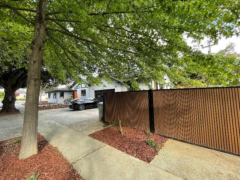 The fence around the side yard as seen from the front of the home.