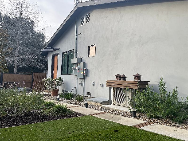 Yard and entrance door seen from other direction.