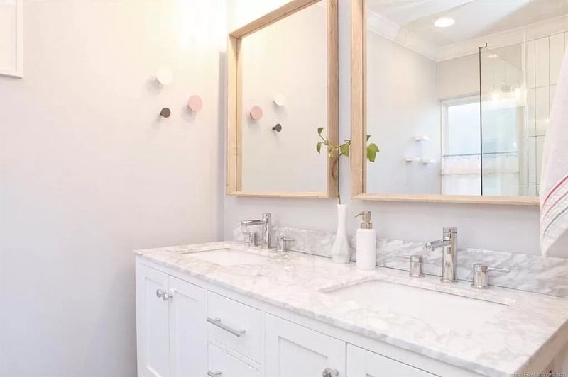 The master bathroom features a dual vanity, complete with power outlets on both sides to charge your toothbrush or power the supplied hair dryer.