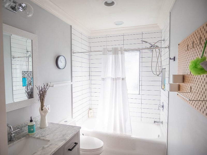 The front bathroom receives a warm, diffused glow in the mornings. This bathroom is complete with a soaking tub and shower, as well as a full-sized stackable washer/dryer.