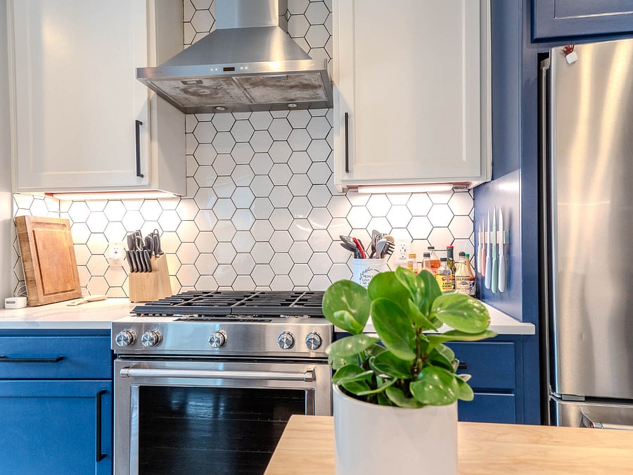 The kitchen is complete with large refrigerator, gas range, oven, microwave, sink, and dishwasher.