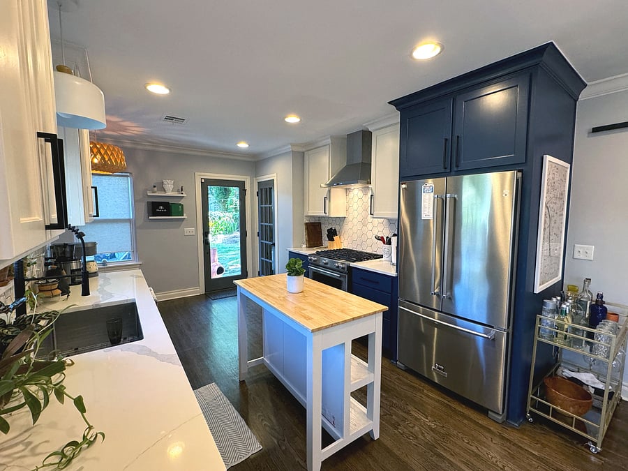 The kitchen is complete with large refrigerator, gas range, oven, microwave, sink, and dishwasher.