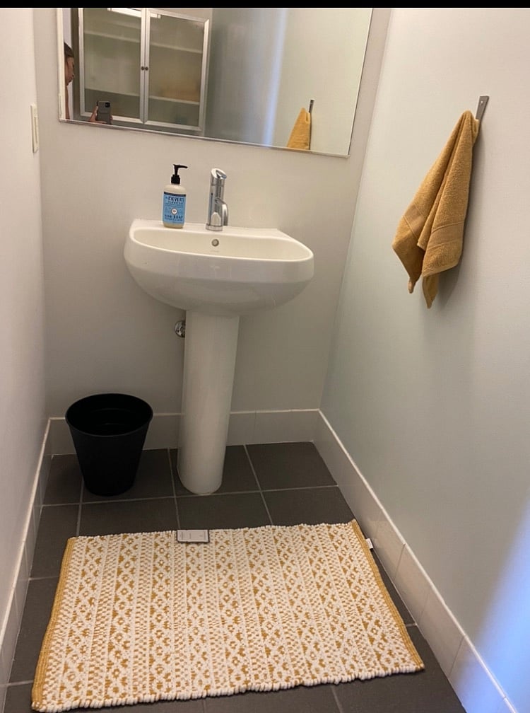 Powder room pedestal sink/toilet/ cabinet for guests.